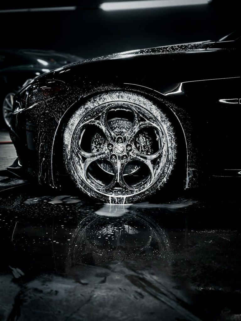 a-close-up-of-a-car-tire-on-a-wet-surface-m5g2ifroucs